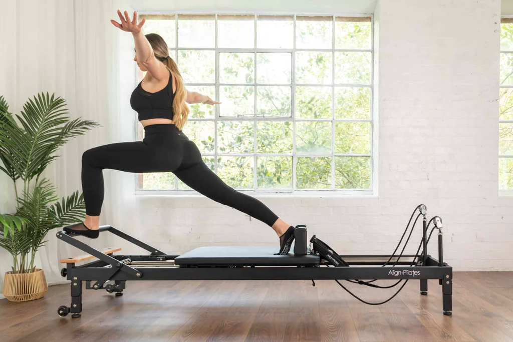 Pilates instructor training on a reformer